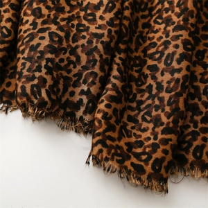 Detail of leopard print scarf fabric showing woven texture and frayed edges