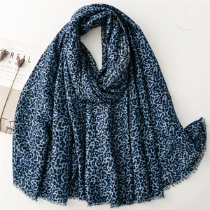 Blue and black leopard print scarf with fringe edges displayed on white background