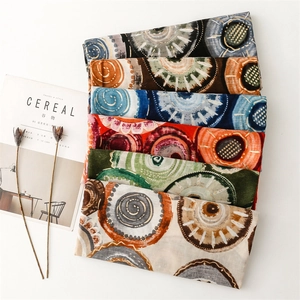 Close-up of bohemian geometric circle pattern scarves in multiple vibrant colors