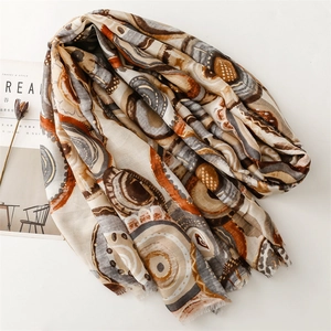 Detail of artistic cotton linen scarf with geometric circle patterns and frayed edges