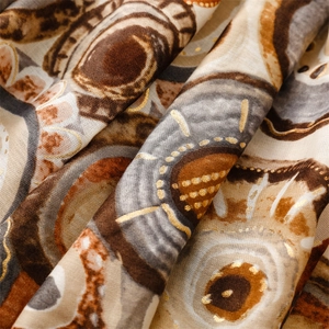 Detail of warm cotton linen scarf with ethnic geometric patterns and gold foil stamping