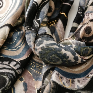 Detailed view of the artistic geometric pattern and gold foil accents on the cotton scarf