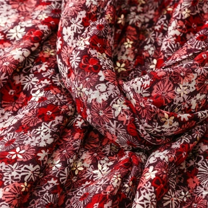 Detail of floral scarf with cotton-linen feel featuring gold foil stamped flower patterns