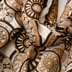 Detail of bohemian cotton linen scarf featuring gold foil geometric patterns and soft texture