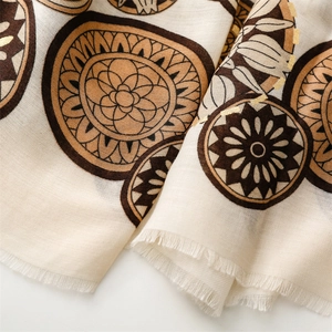 Detail of cotton linen scarf with gold foil wheel patterns and fine fringe edges
