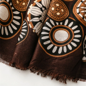 Detail of cotton linen scarf featuring gold foil geometric circles and frayed fringe edges