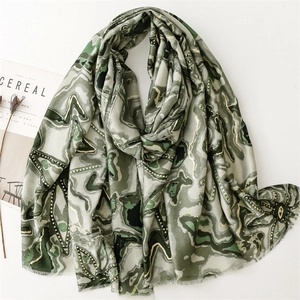 Écharpe artistique en lin de coton vert avec motifs dorés et bords effilochés sur blanc