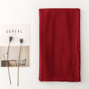 Solid red linen-feel scarf with frayed edges and lightweight fabric for women