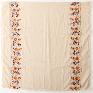Detailed view of exquisite floral embroidery on a soft cotton linen texture shawl scarf