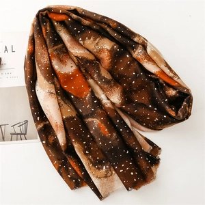 Detail of artistic cotton linen scarf with abstract color block print and fringe edges
