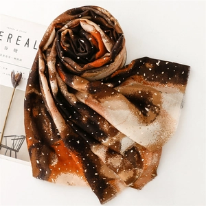 Detailed texture of cotton linen scarf with gold foil dots and colorful gradient patterns