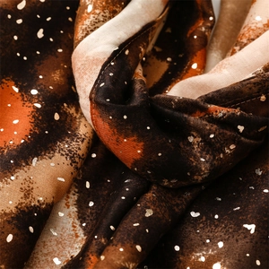 Detail of soft cotton-linen scarf with gold foil accents and artistic gradient print