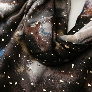 Detail of colorful rendering scarf with golden foil dots and soft textured cotton-linen feel