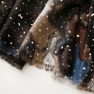 Detail of cotton linen scarf with gold foil printing, camo texture and frayed fringe edges