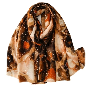 Artistic abstract printed linen-feel scarf with golden warm tones and frayed edges