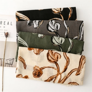 Detail of floral linen scarves with gold tulip outlines in four assorted colors