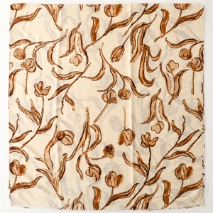 Close-up of hand-painted brown tulip patterns on cream linen feel square scarf