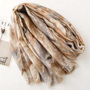 Detail of linen-feel shawl with abstract geometric tie-dye pattern and frayed edge