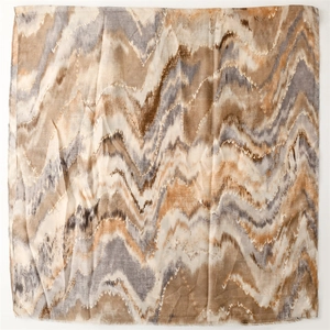 Detail of cotton linen scarf featuring earthy wave patterns and natural frayed edges