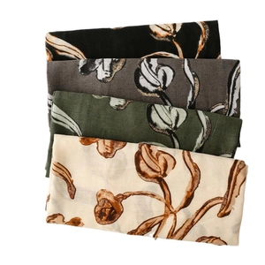 Floral cotton linen scarves in black, grey, green, and beige with gold tulip prints