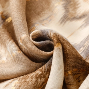 Detail of cotton-linen scarf with gold foil mountain pattern and rich fabric texture