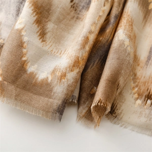 Macro detail of abstract wave pattern on soft cotton-linen scarf with fringed edges