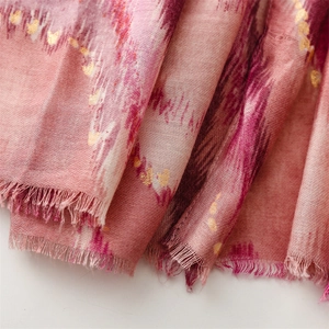 Detail of pink cotton-linen scarf with gold foil hearts and fringe edges