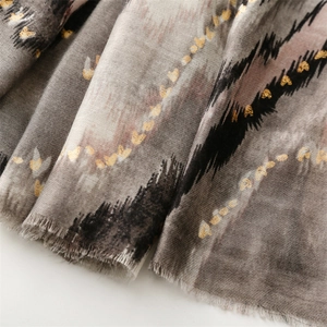 Detail of gold heart pattern and mountain wave texture on a cotton linen scarf