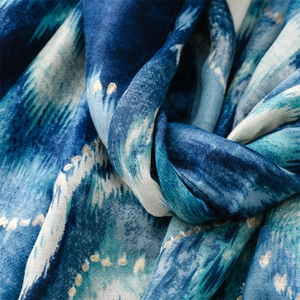 Detailed macro shot of blue mountain wave pattern scarf with luxury gold foil accents