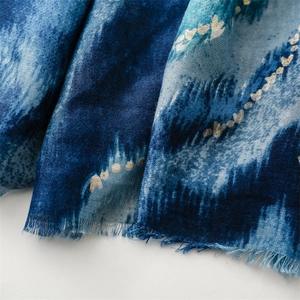 Close-up of blue gradient cotton linen scarf with gold heart foil and fringe detail