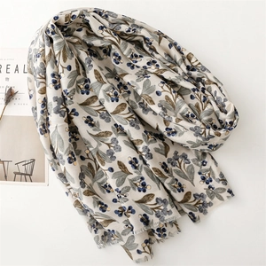 Detail of soft linen scarf with vintage botanical prints and frayed fringe edges