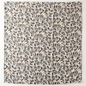 Detail of off-white cotton-linen scarf with blue berry floral print and frayed edges