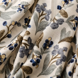 Close-up of soft linen cotton scarf with gold floral prints and navy berry patterns
