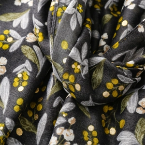 Detail of dark gray scarf with floral print and gold foil botanical patterns