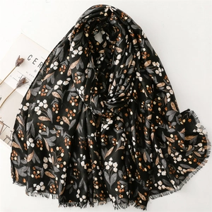 Floral print cotton linen scarf with frayed edges and delicate leaf pattern in black