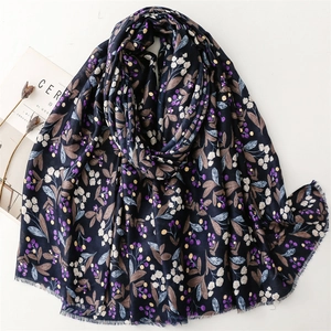 Detail of navy cotton-linen scarf with purple berry print and frayed edges