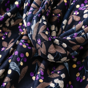 Detail of floral linen-feel scarf with gold foil accents and purple berry patterns