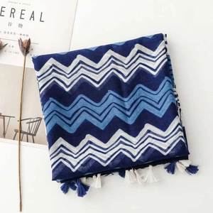 Detail showing blue and white wavy pattern cotton-linen scarf with fringed tassels