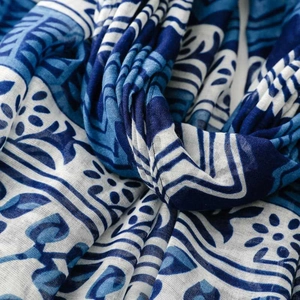 Detailed macro shot of blue and white ethnic porcelain pattern on soft tassel shawl