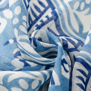 Macro detail of blue and white geometric floral pattern on woven bali yarn scarf fabric