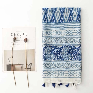 Detail of blue and white ethnic pattern shawl with soft tassels and geometric prints