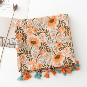 Detail of orange floral print scarf with contrasting tassel charms on thin Bali yarn