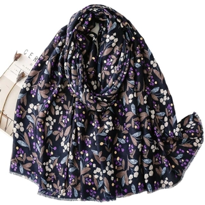 Black cotton linen scarf with purple berry floral print and fringe edges as a shawl
