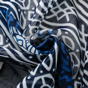 Macro shot of blue and white geometric print on lightweight ethnic bali yarn scarf fabric