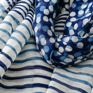 Detail of soft blue stripe and polka dot pattern on lightweight voile scarf fabric