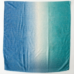Detail of blue and green gradient cotton-linen scarf with gold foil dots and frayed edges