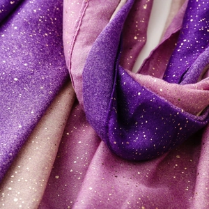 Detail of purple to pink gradient scarf with delicate gold glitter and woven texture