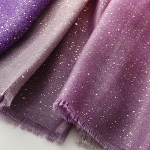 Detail of purple gradient shawl with gold foil accents and soft fringe edges