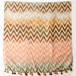 Macro detail of zigzag chevron pattern and fringe tassels on lightweight gradient shawl
