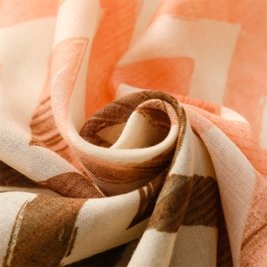 Close-up of geometric pattern scarf with soft cotton-linen texture and fringe